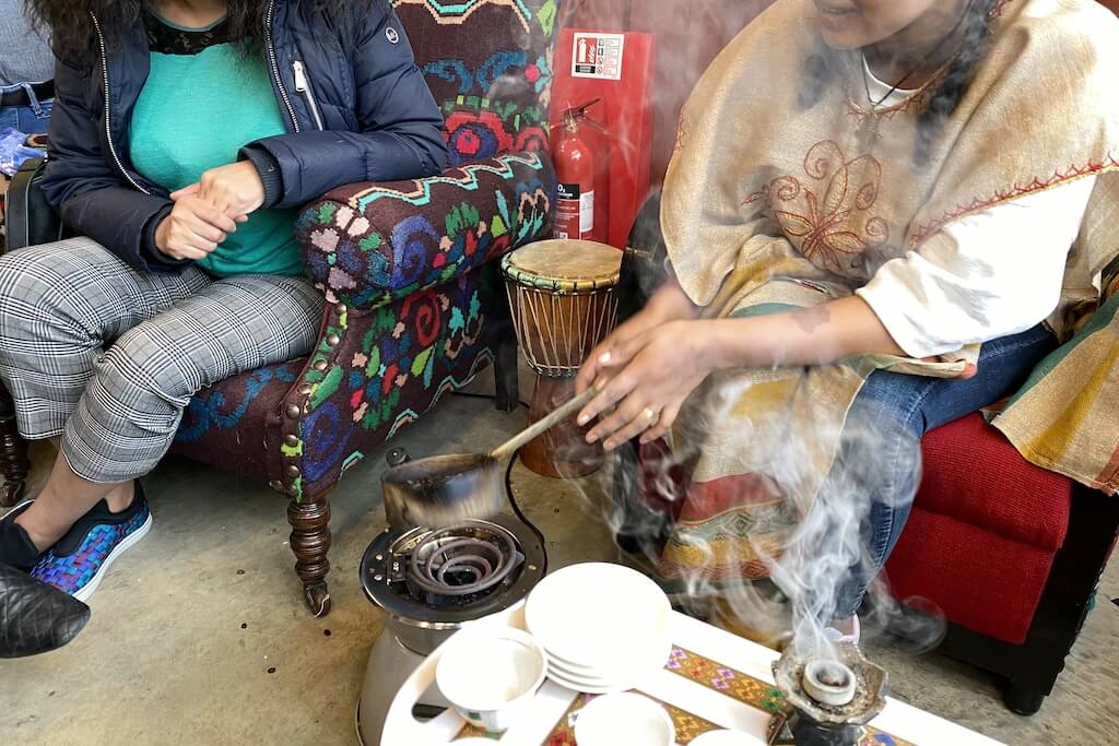 A female Ethiopian shaman starting the coffee ceremony that you'll experience on this tour.