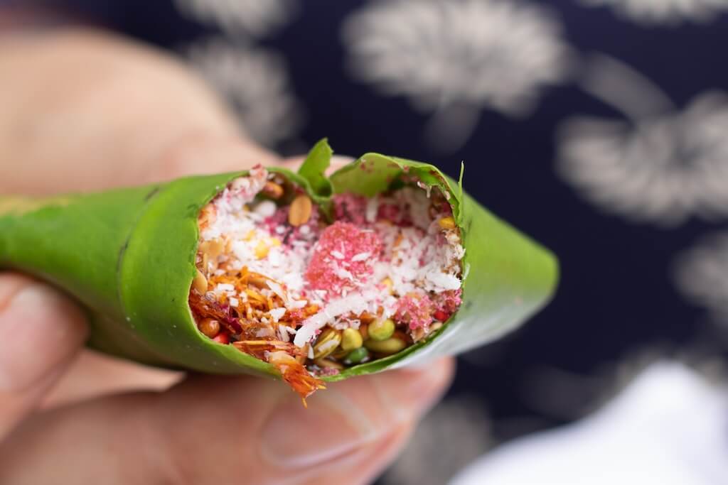 A close-up of a traditional Indian meal wrapped in a leaf served at one of the best Indian restaurants in London.