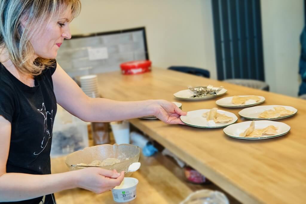 A waitress inside a traditional Ukrainian restaurant in Edinburgh, preparing tastings of typical Ukrainian food for the guests on the tour.