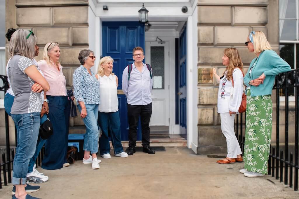 A local tour guide, Nataliya, speaking in front of her group of guests in front of the Ukrainian Community Centre in Edinburgh.