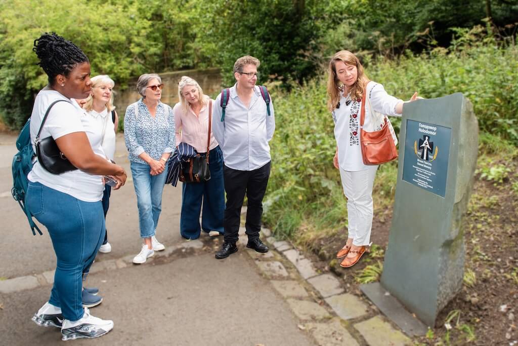 Nataliya pointing out the Holodomor Memorial Stone to her group of guests during the Ukrainian tour.