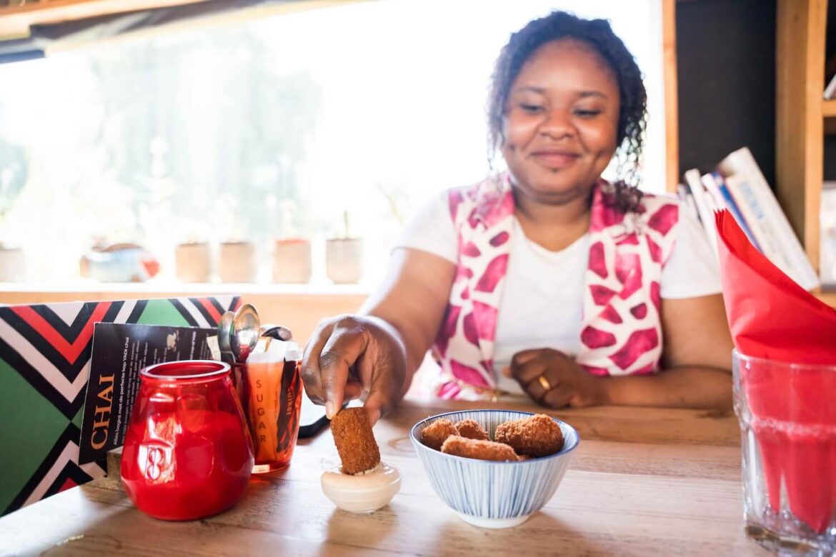 Tour guide enjoying a Surinamese-Indonesian snack during the coffee break in Amsterdam Zuidoost.