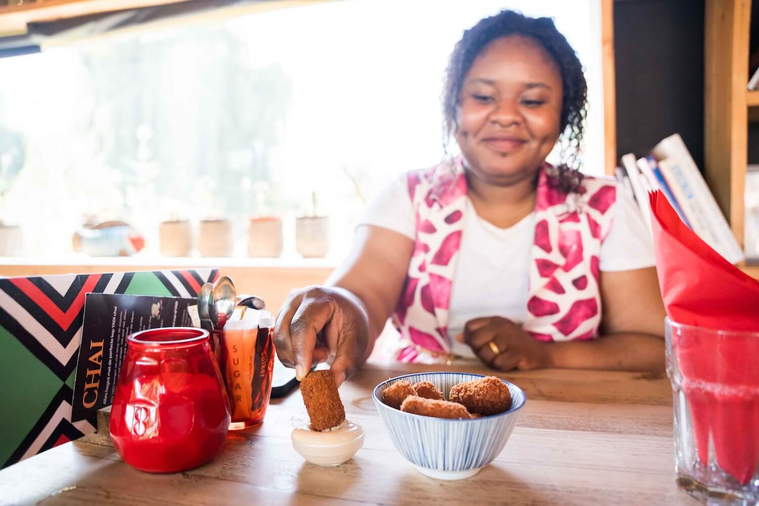 Tour guide enjoying a Surinamese-Indonesian snack during the coffee break in Amsterdam Zuidoost.