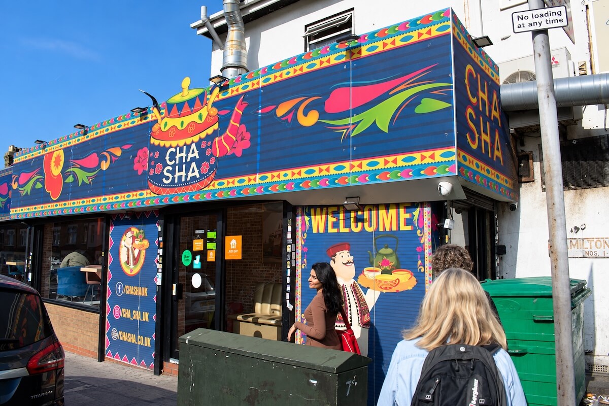 Colourful Cafe Cha Sha storefront in Ilford, a Pakistani chai stop on the East London food and culture tour