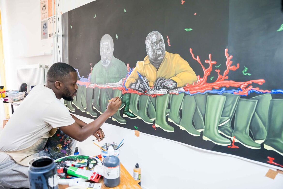 Congolese artist painting a large contemporary artwork during a behind-the-scenes Amsterdam studio visit.