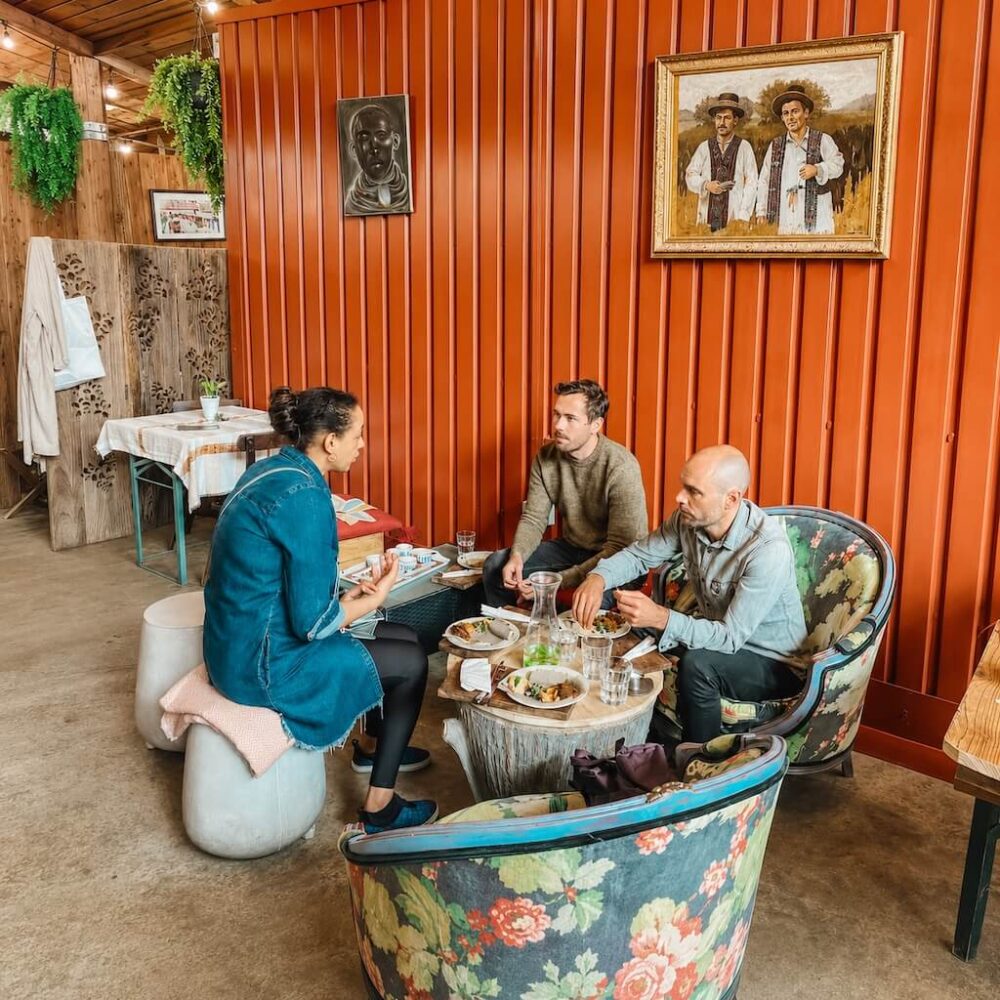 Guests sharing Ethiopian food with their guide during a women-led tour in London.