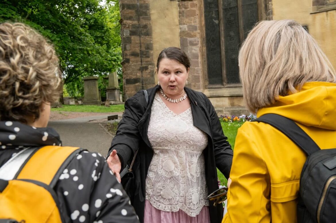 Guide Pola sharing hidden histories with guests near Greyfriars Kirkyard in Edinburgh