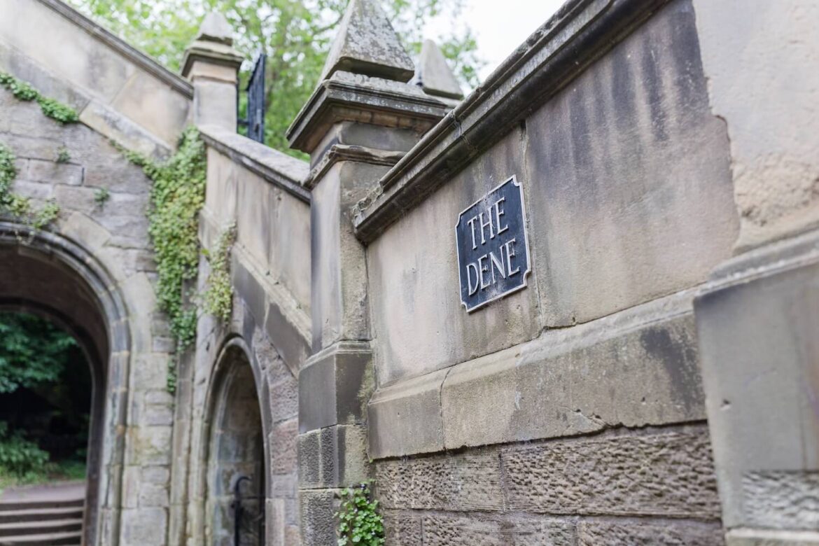 Stone archway marked The Dene beneath St Deans Bridge, the meeting point for the Hidden Edinburgh Nature Tour.