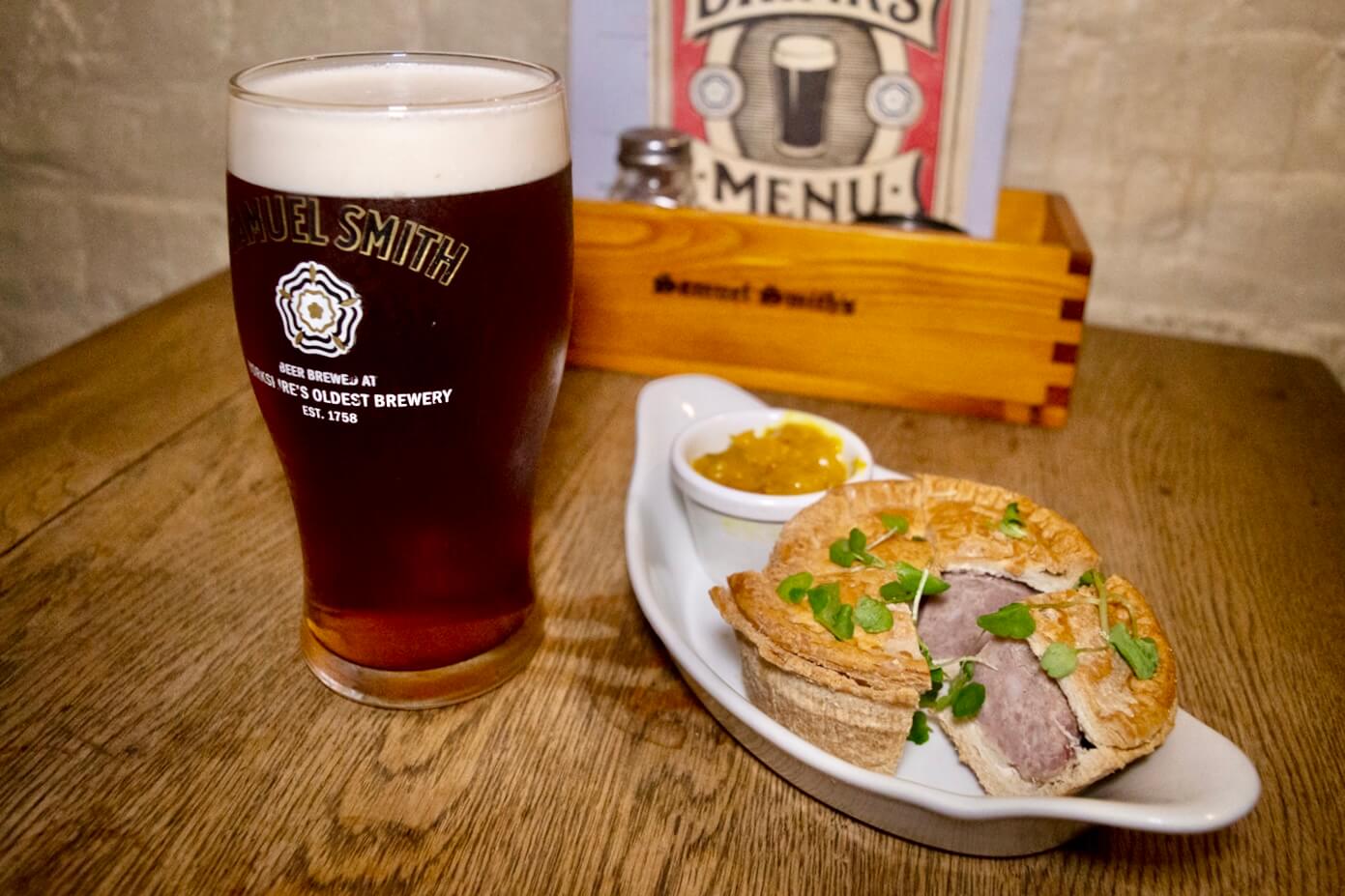 Traditional ale, British pie and chutney served on a London historical food tour exploring migration and food history.