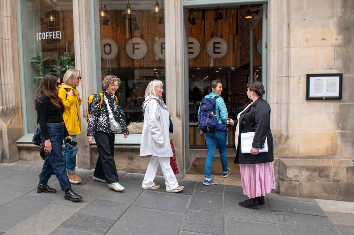 Guide and guests entering the Edinburgh café stop for tea and scones