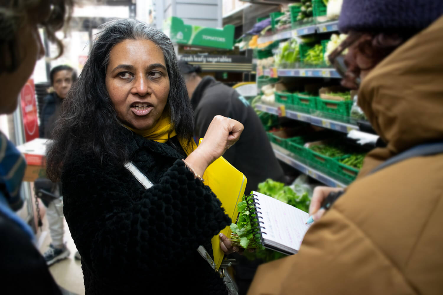 Ranji sharing stories with guests inside a Tooting food market