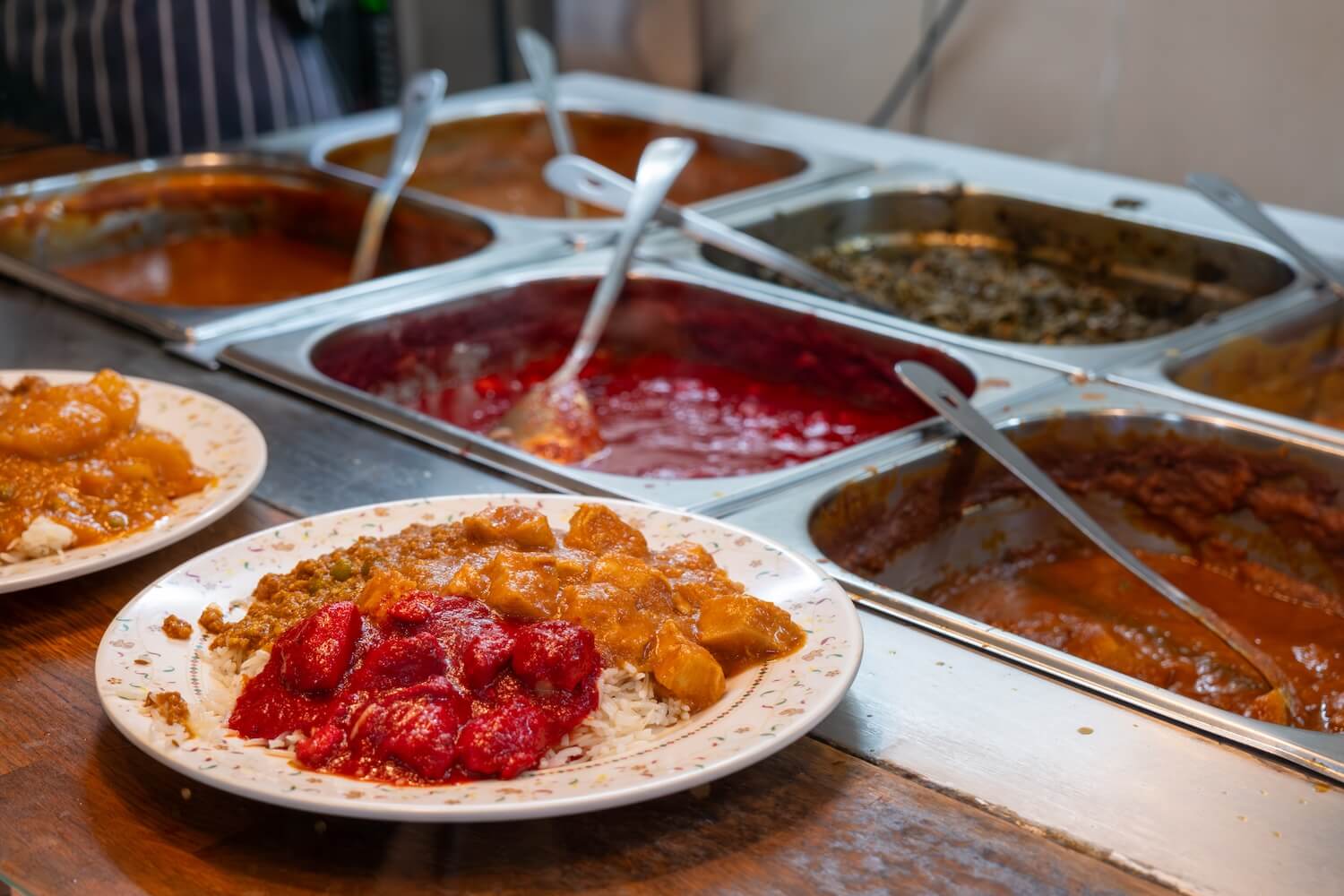 Rice and three dishes being served at This & That Café in Manchester.