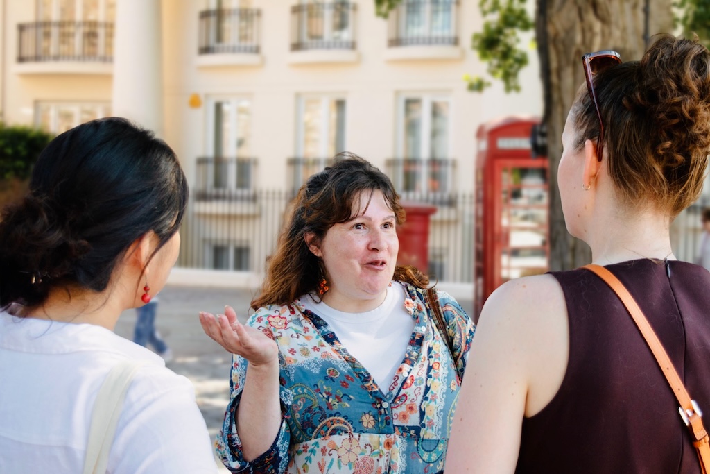 The local guide, Florbela, explaining something passionately to her guests on the Iberian Tour seen from behind.